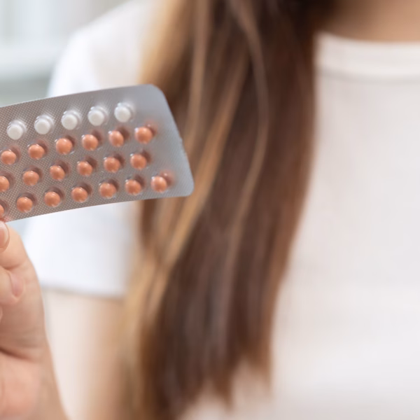 Contraception and pregnancy, menstruation concept, birth control pills asian young woman hand holding hormonal oral contraceptive medicine, take pharmaceutical to prevention, safe virus sex disease.
